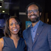 Man and woman smile together at camera